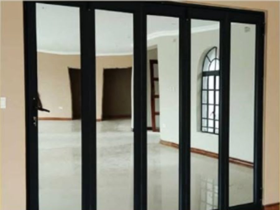 Black aluminium folding sliding doors installed between two rooms