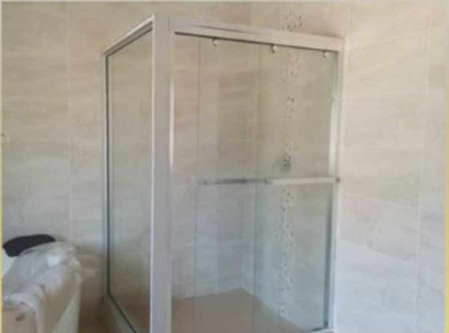 Framed shower enclosure fitted into a tiled bathroom