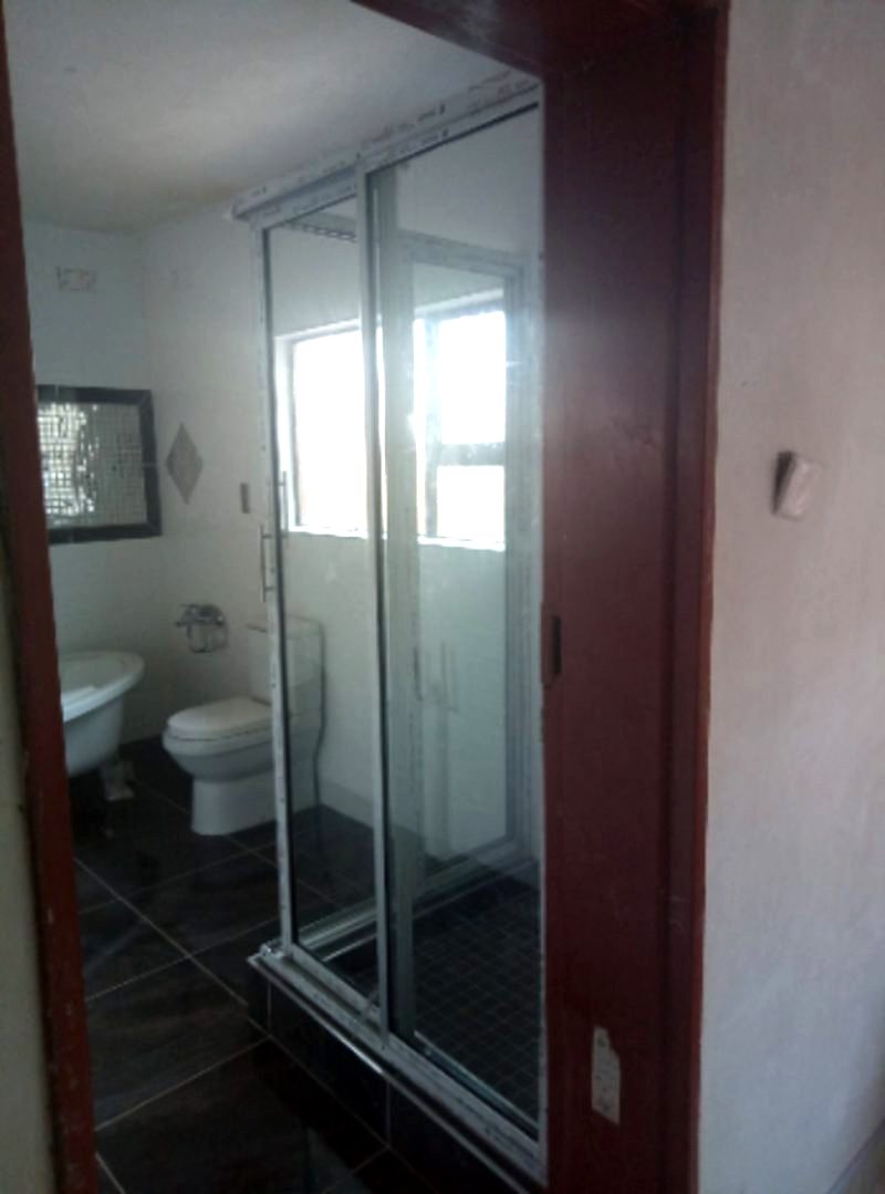 Sliding shower enclosure