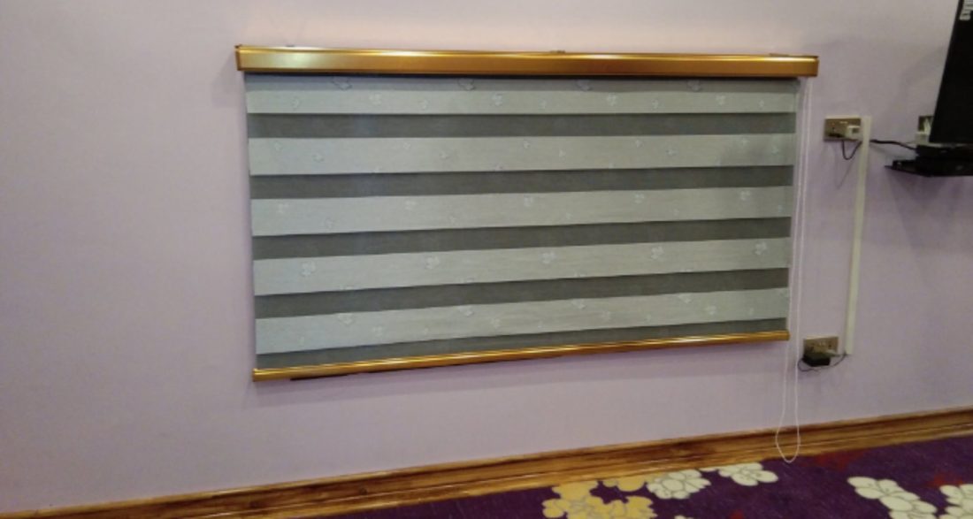 Day-and-night zebra blind fitted on a lounge wall